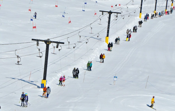 riding T-bar lift on snowboard riding T-bar lift on snowboard