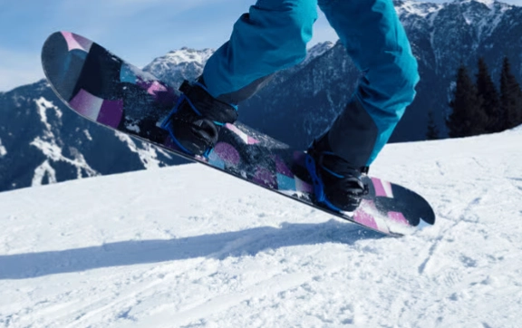 riding T-bar lift on snowboard riding T-bar lift on snowboard