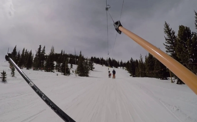 riding T-bar lift on snowboard riding T-bar lift on snowboard